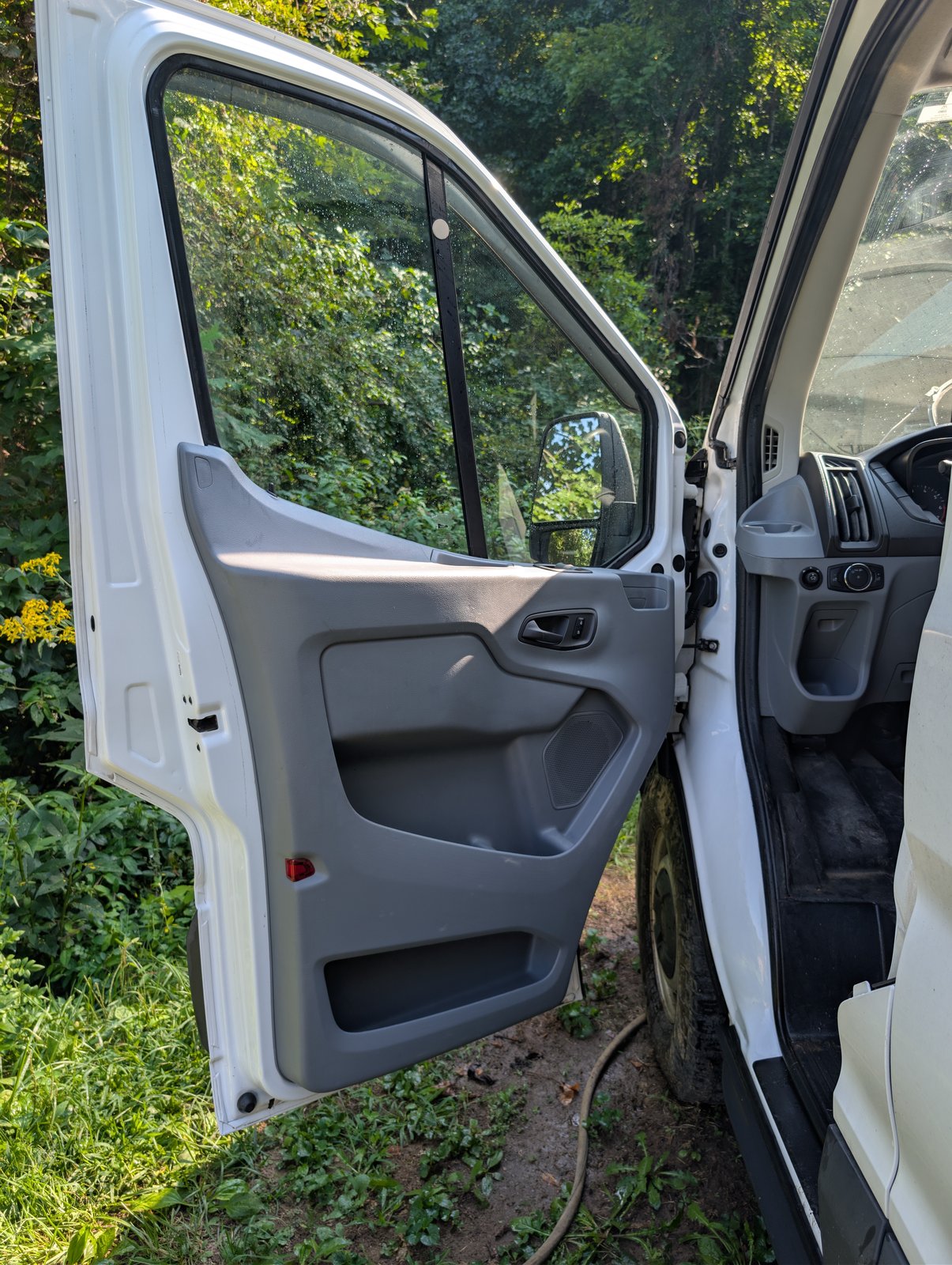 Driver's door open, showing the door card and cab condition
