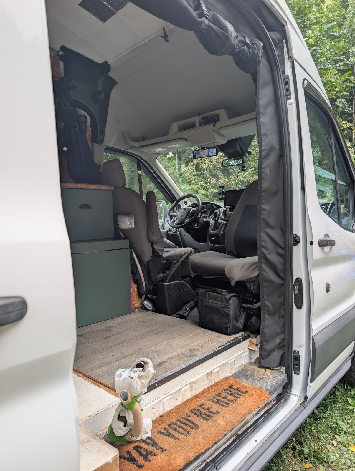 Looking forward through the sliding door towards the cab and swivel passenger seat