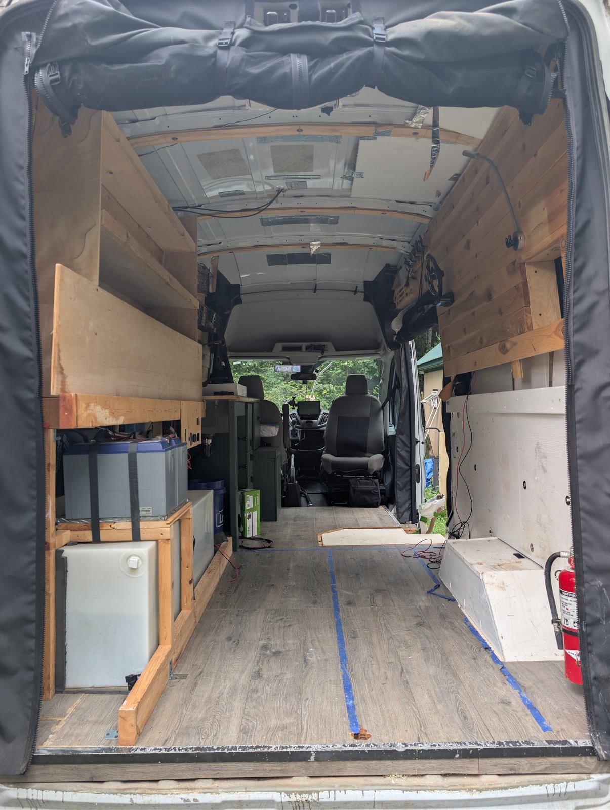 Interior looking forward from the rear doors, showing the full length of the van